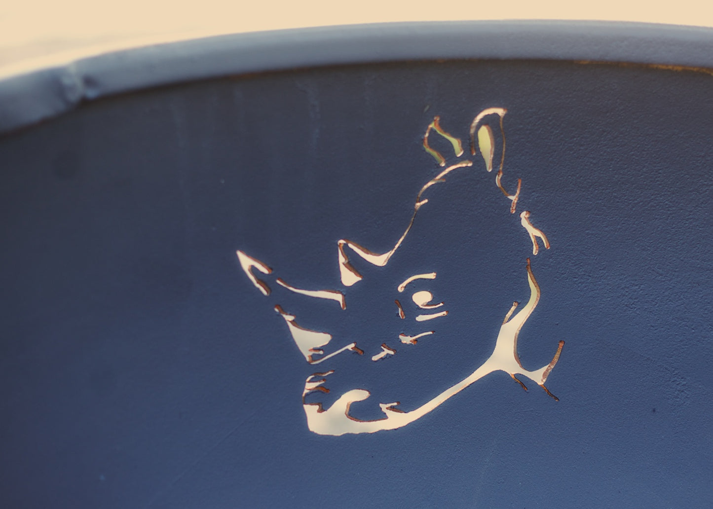 Inside perspective of rhino silhouette on fire pit’s inner wall.