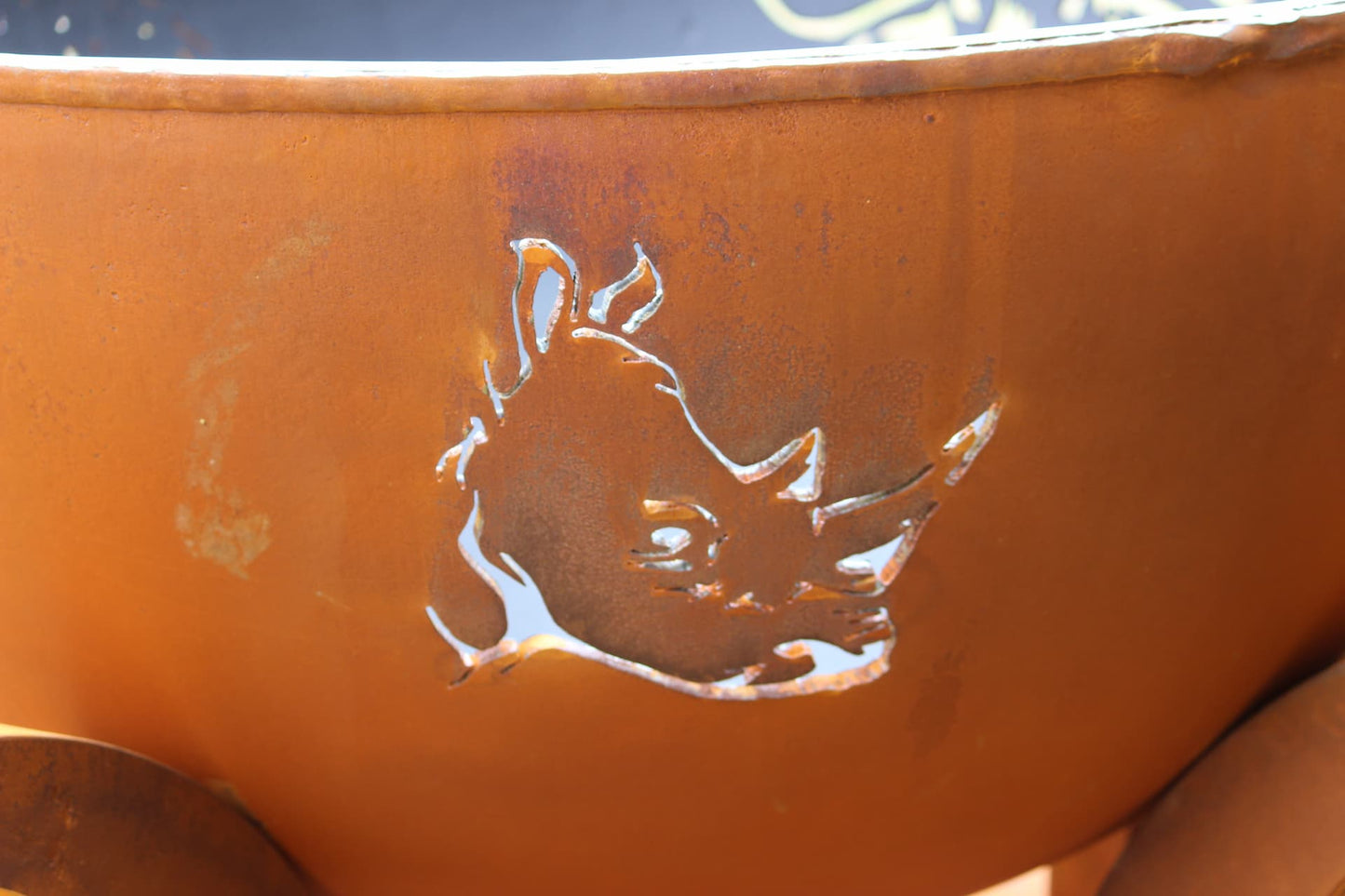 Rhino head cutout detail on carbon steel fire pit by Fire Pit Art.