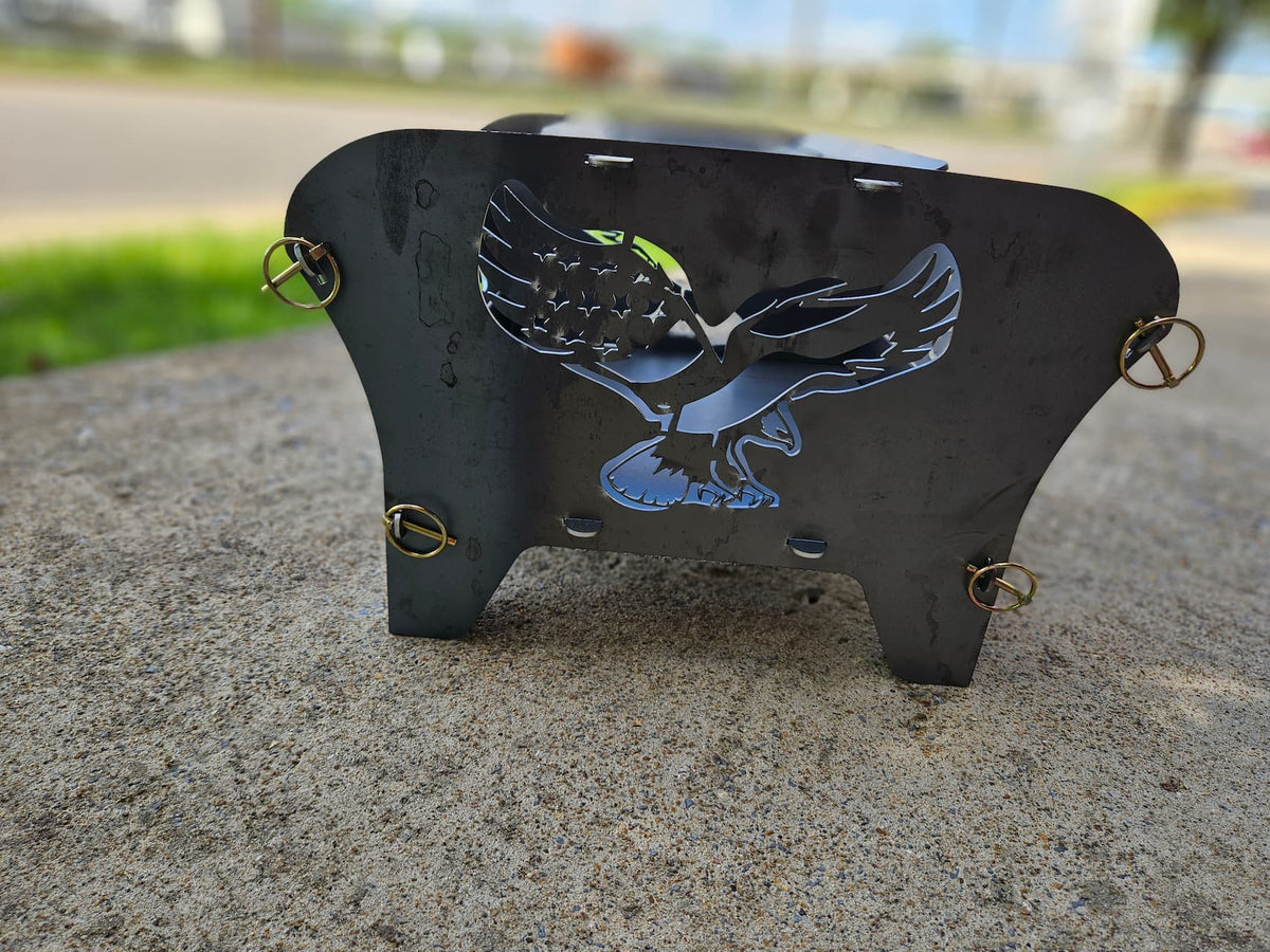 Side view of the Freedom steel collapsible fire pit with an American Eagle.