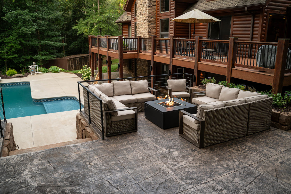 Outdoor sectional around The Milan Propane Fire Table - Square at a rustic lodge with poolside view (pictured in Endura Graphite, wind shield sold separately).