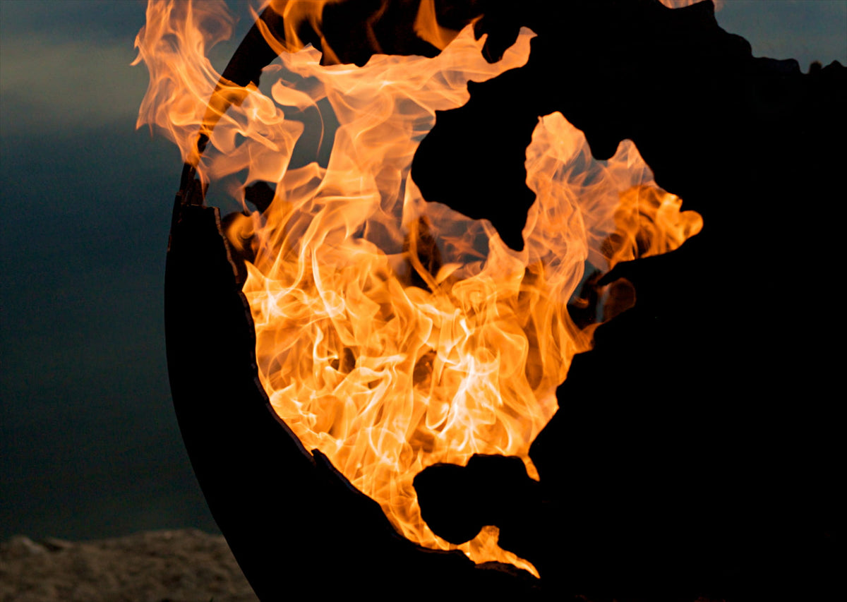 Close-up of flames inside the Third Rock fire pit, highlighting North America design in steel.