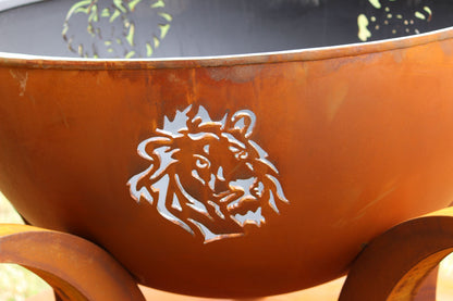 Detailed lion cutout on exterior of Africa’s Big Five patina fire pit by Fire Pit Art. 