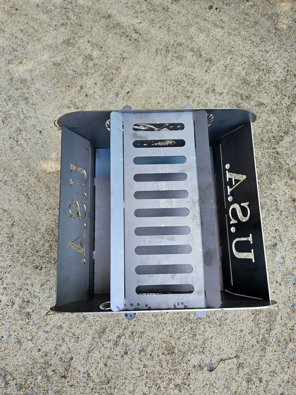 Overhead view of the Freedom steel collapsible fire pit with grill area.