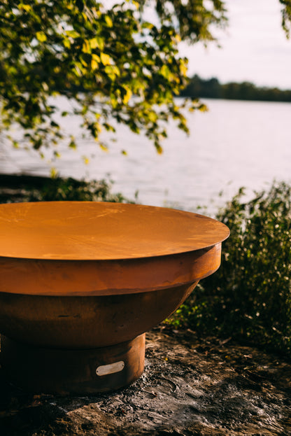 Sideview of Fire Pit Art’s 40” Carbon Steel Table Top Lid showcasing the beautiful iron oxide patina.