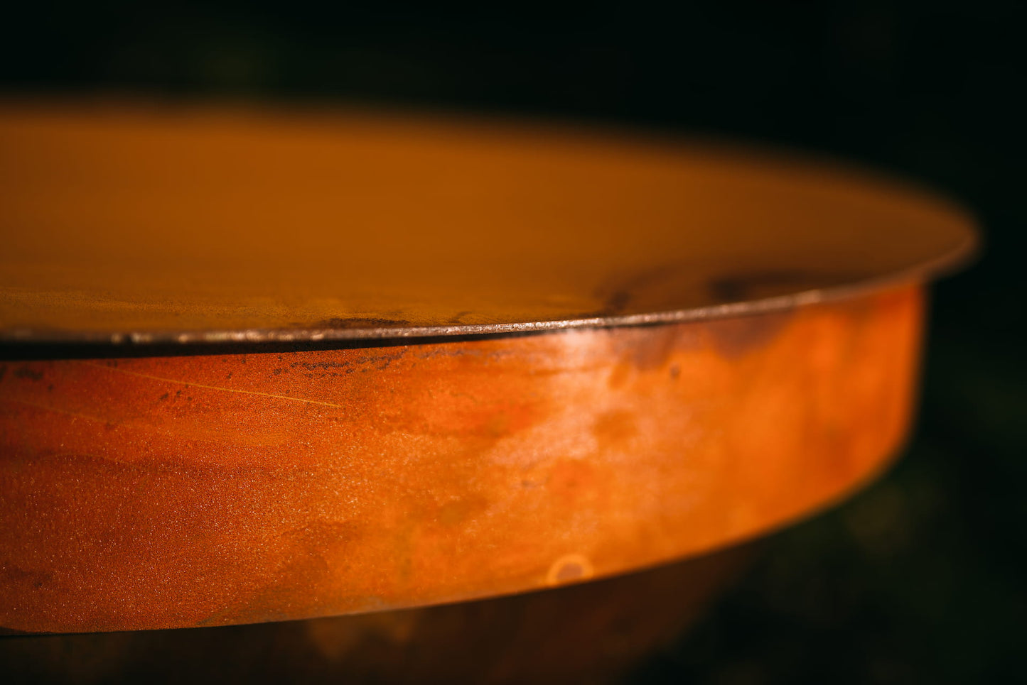 Sideview of Fire Pit Art 43” Carbon Steel Table Top Lid created to cover the following 41” Fire Pit Art styles: Nepal and Barefoot Beach (sold separately).