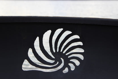 Close-up of seashell design cut into the Beachcomber 36" steel fire pit side. Made in the USA.