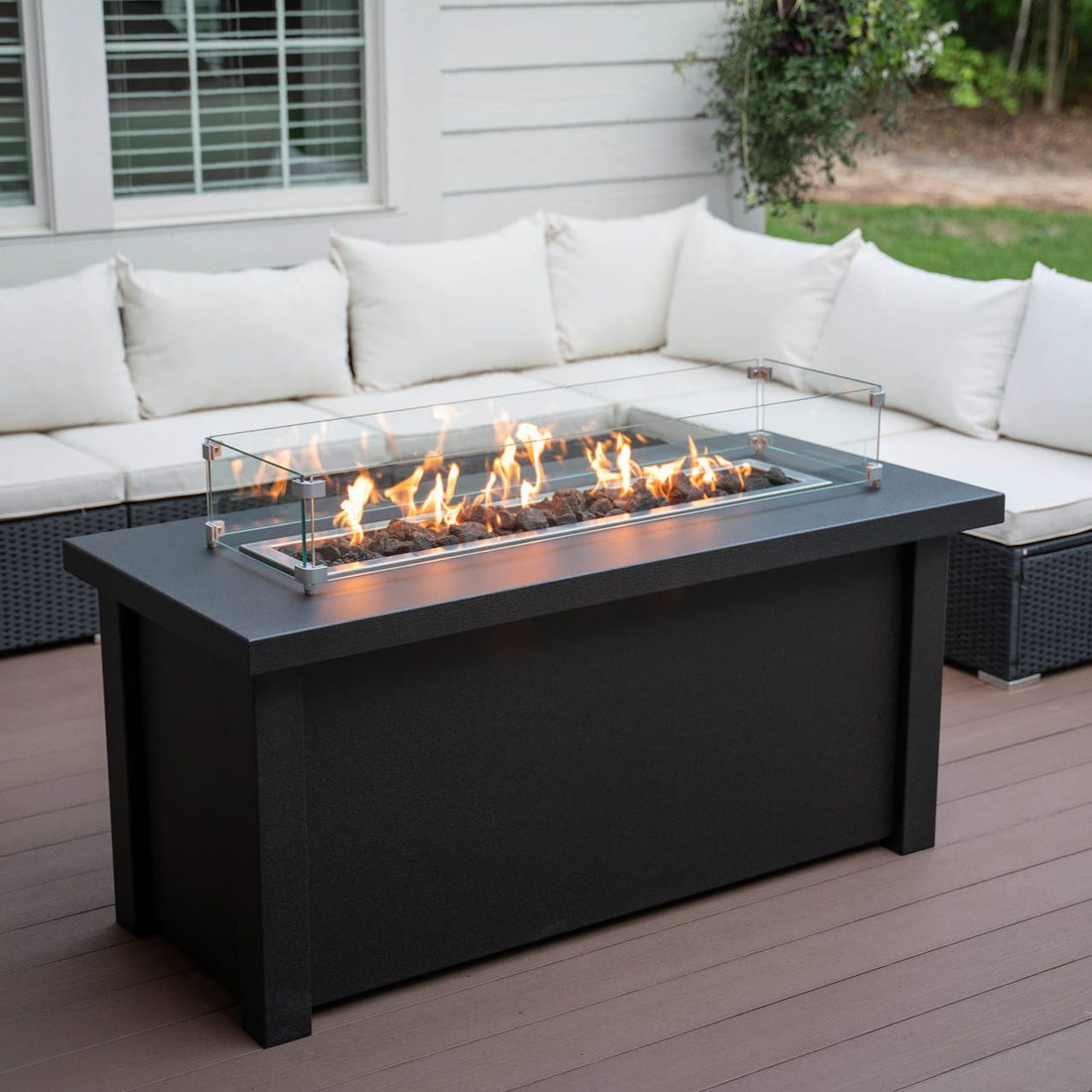 Lit Carolina Evening Companion Linear propane fire pit table in Endura Graphite on a patio.  Made in the USA.  Wind shield sold separately.

