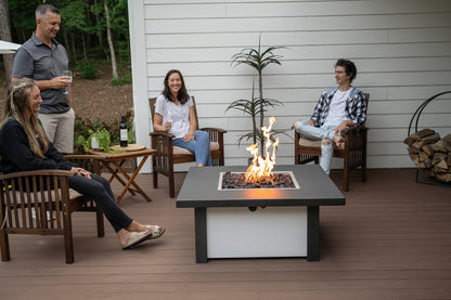 Group of friends gathered around lit Carolina Evening Companion Square fire table enjoying wine and conversation outdoors (table shown in Endura Charcoal and White).