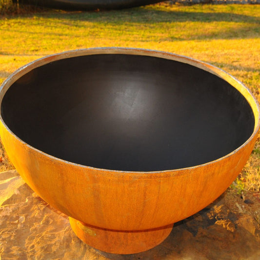 Crater 36 inch carbon steel fire pit by Fire Pit Art with matte black interior and rustic patina finish.  Made in USA.