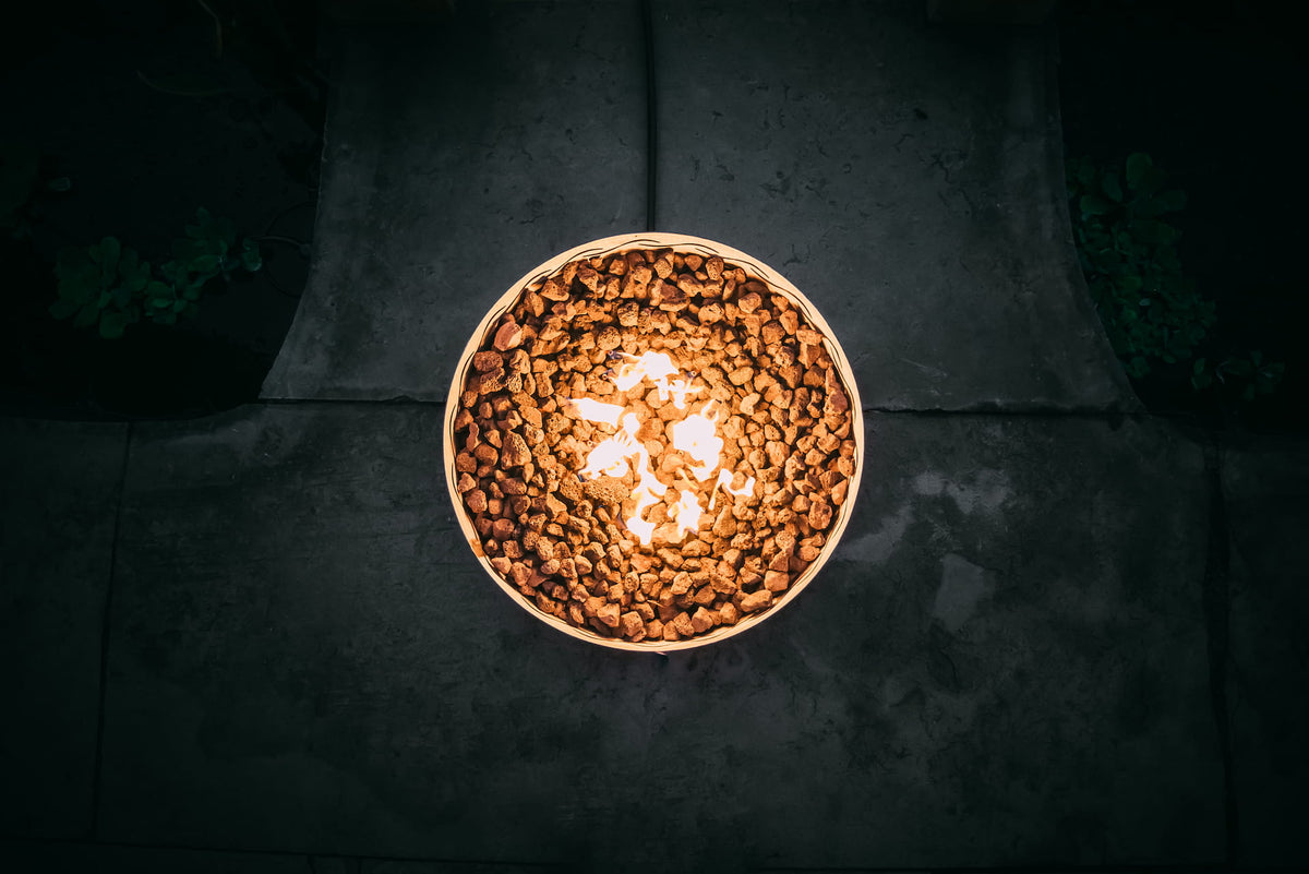 Overhead view of Fire Surfer fire pit with flame and lava rocks.