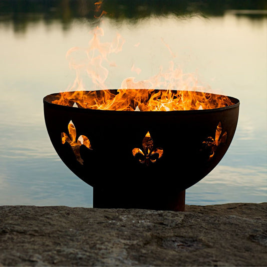 Fleur de Lis 36 inch carbon steel fire pit by Fire Pit Art with flame-lit cutouts and rustic iron oxide finish.  Made in the USA.