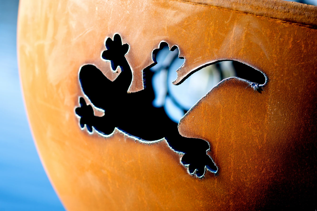 Gecko cutout on weathered carbon steel fire pit with rich patina.  Made in the USA by Fire Pit Art.