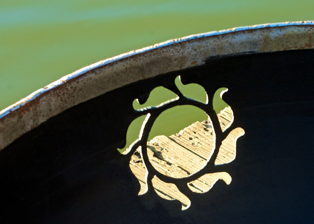 Close-up of sunburst cutout detail on Kokopelli fire pit.