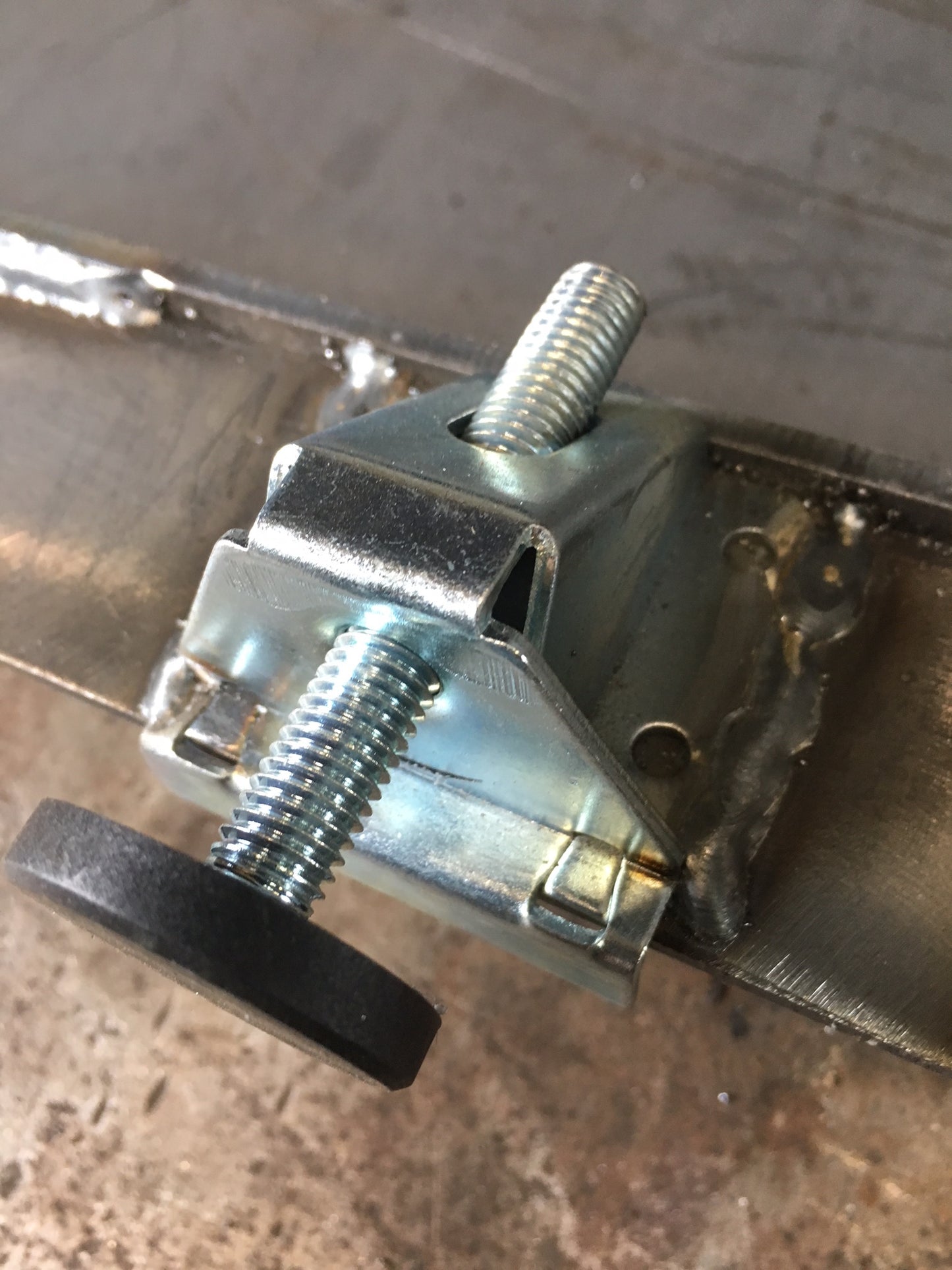 Close-up of the adjustable steel leveling foot used on the Linear fire pit.