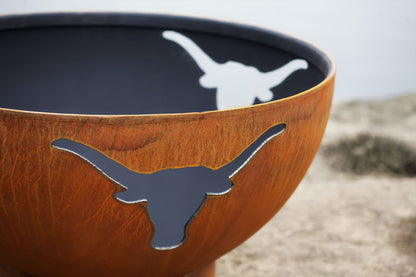 Close view of fire flickering through longhorn cutout in Long Horn 36" carbon steel fire pit by Fire Pit Art.  Made in USA.