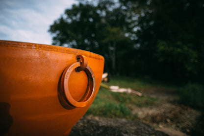  Close-up of Nepal 41" carbon steel fire pit's steel ring handle with natural patina finish.