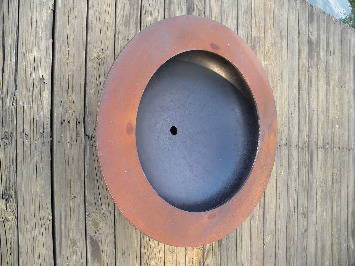 Top-down view of the Saturn 41-inch carbon steel fire pit with a large open bowl and central drainage hole.