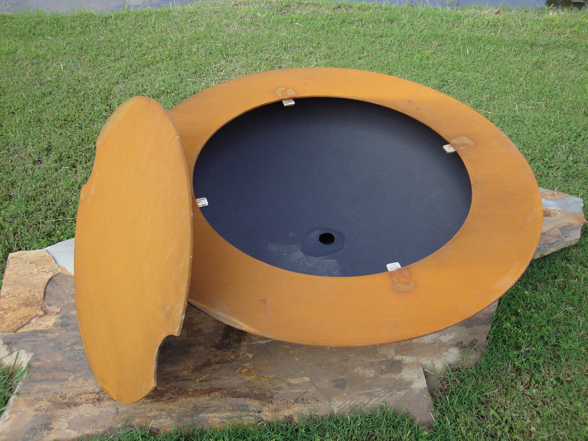 Saturn fire pit with lid partially removed, showing welded interior support tabs and black steel fire bowl inside. Made in USA by Fire Pit Art.