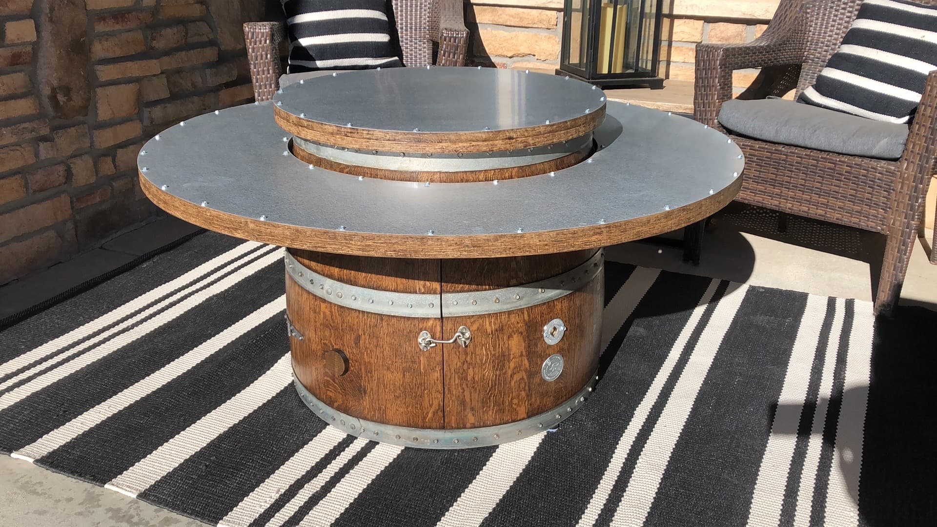 46" wine barrel coffee table fire pit with lid closed on patio with chairs – doubles as a sturdy outdoor table when the fire is not in use.  Made in the USA.