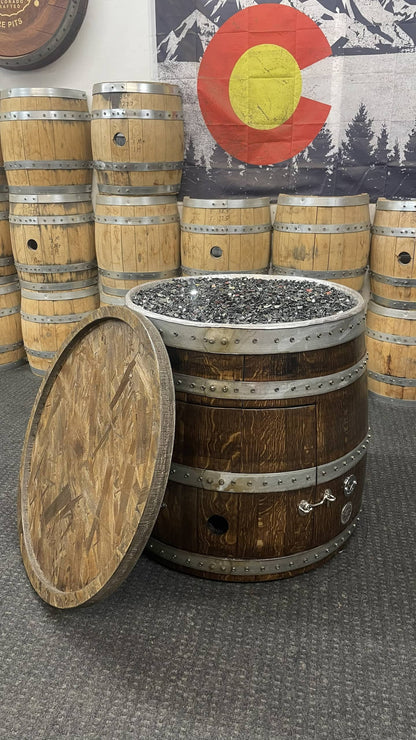 Wine barrel fire pit with removable matching lid displayed in showroom setting.